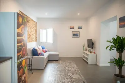 a living room with a couch and a tv at Acogedor y luminoso apartamento in Cádiz