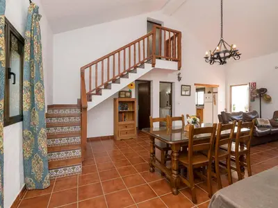 a living room with a table and a staircase at Holiday Home Amado by Interhome in Conil de la Frontera