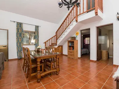 a dining room with a table and chairs and a staircase at Holiday Home Amado by Interhome in Conil de la Frontera