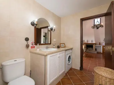 a bathroom with a toilet and a sink and a mirror at Holiday Home Amado by Interhome in Conil de la Frontera