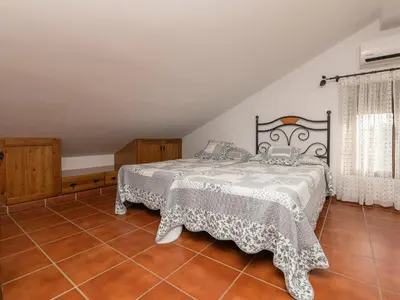 a bedroom with two beds on a tiled floor at Holiday Home Amado by Interhome in Conil de la Frontera