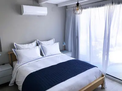 a bedroom with a large bed with a window at El Palomar de Menacho in Cádiz