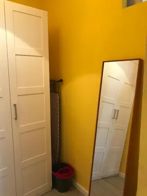 a mirror in a room with a yellow wall at El Palomar de Menacho in Cádiz