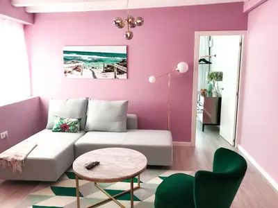 a living room with purple walls and a couch and a table at El Palomar de Menacho in Cádiz