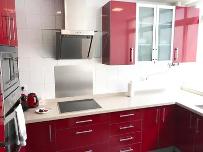 a kitchen with red cabinets and a sink at El Palomar de Menacho in Cádiz
