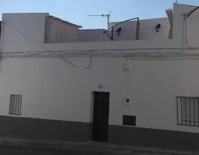 a white building with a door on the side of it at Casa Alegría in Jerez de la Frontera