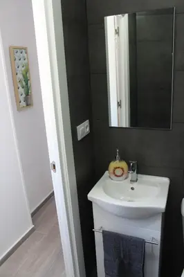 a bathroom with a sink and a mirror at Casa Alegría in Jerez de la Frontera