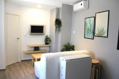 a living room with a couch and a tv at Casa Alegría in Jerez de la Frontera