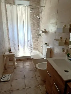 a bathroom with a shower and a toilet and a sink at Casa Rural Vacacional in Puerto Real