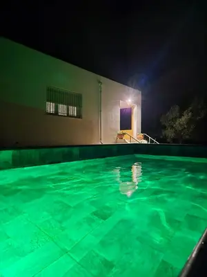 a swimming pool in a house at night at Casa Rural Vacacional in Puerto Real