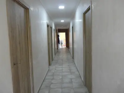 a hallway with a long corridor with two doors at Casa Rural Vacacional in Puerto Real