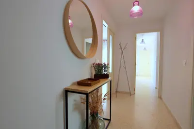a hallway with a mirror and a table with a mirror at Sanlúcar Apart Airen!! in Sanlúcar de Barrameda