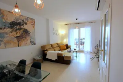 a living room with a couch and a glass table at Sanlúcar Apart Airen!! in Sanlúcar de Barrameda
