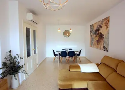 a living room with a couch and a table at Sanlúcar Apart Airen!! in Sanlúcar de Barrameda
