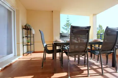 a dining room with a table and chairs and a window at Sanlúcar Apart Airen!! in Sanlúcar de Barrameda