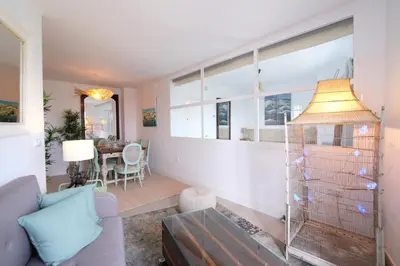 a living room with a couch and a table at Fabuloso Ático con vistas al mar in Cádiz