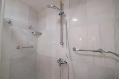 a bathroom with a shower with a glass door at Fabuloso Ático con vistas al mar in Cádiz