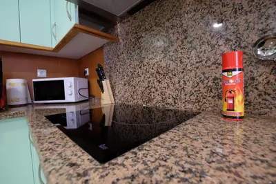 a kitchen counter with a fire extinguisher on it at Fabuloso Ático con vistas al mar in Cádiz