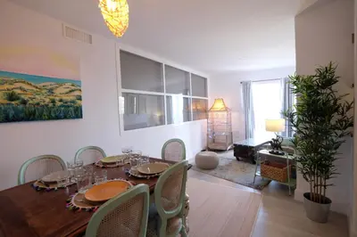 a dining room with a wooden table and chairs at Fabuloso Ático con vistas al mar in Cádiz