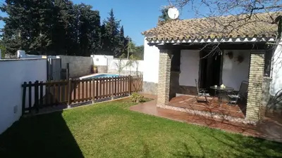 a backyard with a pool and a house at Cortijo El Almendro, Urb. Fuente del Gallo, Conil in Conil de la Frontera