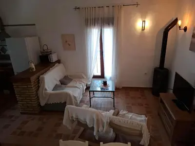 a living room with a white couch and a window at Cortijo El Almendro, Urb. Fuente del Gallo, Conil in Conil de la Frontera