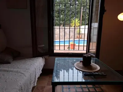 a room with a glass table and a window at Cortijo El Almendro, Urb. Fuente del Gallo, Conil in Conil de la Frontera