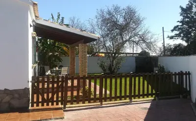 a wooden fence with a gate in a yard at Cortijo El Almendro, Urb. Fuente del Gallo, Conil in Conil de la Frontera
