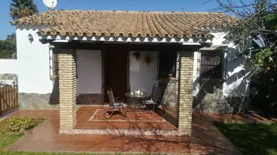 a patio in front of a white house at Cortijo El Almendro, Urb. Fuente del Gallo, Conil in Conil de la Frontera