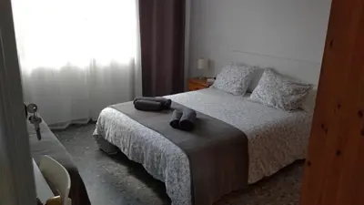 a bedroom with a bed with two towels on it at BNB LOLA - Habitacion con Baño privado en el pasillo y aire acondicionado in Puerto Real
