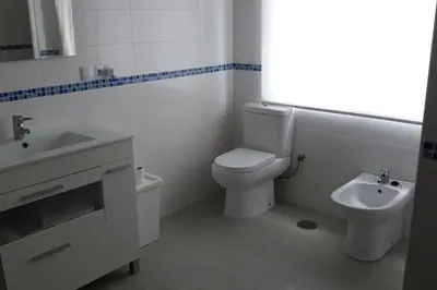 a white bathroom with a toilet and a sink at BNB LOLA - Habitacion con Baño privado en el pasillo y aire acondicionado in Puerto Real