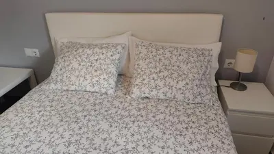 a bedroom with a bed with pillows and a white bedspread at BNB LOLA - Habitacion con Baño privado en el pasillo y aire acondicionado in Puerto Real