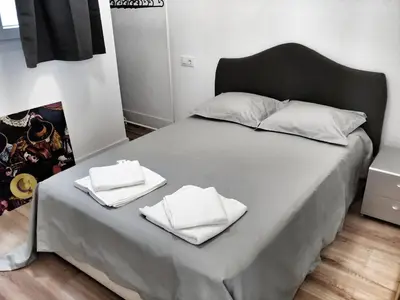 a bed with two white towels on top of it at Casa Crespo in Cádiz