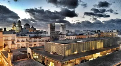 a view of a city with buildings and clouds at Casa Crespo in Cádiz