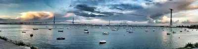 a group of boats in the water under a bridge at Casa Crespo in Cádiz