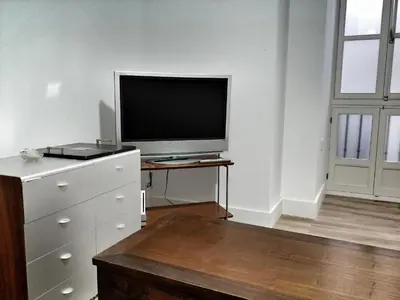 a living room with a flat screen tv on a dresser at Casa Crespo in Cádiz