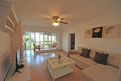 a living room with a couch and a tv at Apto Terrazas 3 Rooms 2 baños Cabildo Playa Parking in Sanlúcar de Barrameda