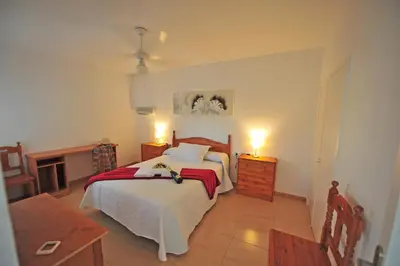 a bedroom with a bed and a fireplace at Apto Terrazas 3 Rooms 2 baños Cabildo Playa Parking in Sanlúcar de Barrameda