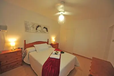 a bedroom with a bed with a dresser and two lamps at Apto Terrazas 3 Rooms 2 baños Cabildo Playa Parking in Sanlúcar de Barrameda