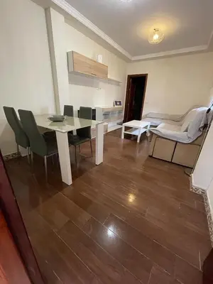 a living room with a dining table and chairs at MARIÑIGUEZ APARTAMENT. in Jerez de la Frontera
