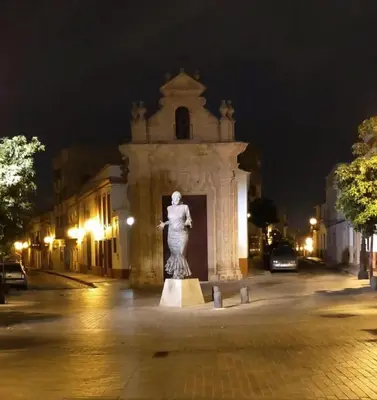 a statue in front of a building at night at MARIÑIGUEZ APARTAMENT. in Jerez de la Frontera