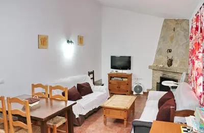 a living room with a couch and a table at Casa Calas Boliña in Roche