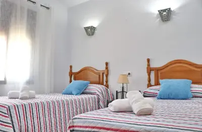 a bedroom with two beds with towels on them at Casa Calas Boliña in Roche