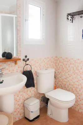 a bathroom with a toilet and a sink at Una ventana al mar in Rota