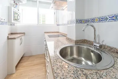 a kitchen with a sink and a counter top at La casa de las margaritas in Cádiz