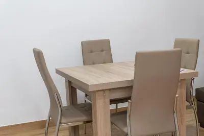 a wooden table with four chairs around it at La casa de las margaritas in Cádiz