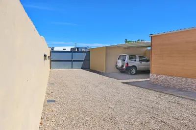 a car parked in a driveway next to a garage at Bungalow con piscina privada in Conil de la Frontera
