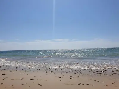 a sandy beach with the ocean in the background at Victoria Chipiona Unifamiliar in Chipiona
