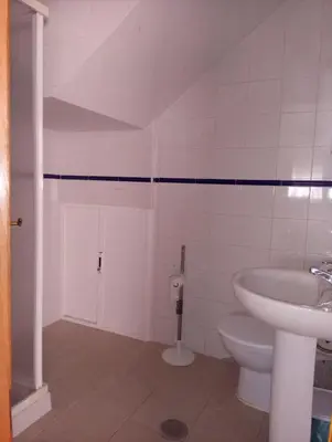 a bathroom with a toilet and a sink at Victoria Chipiona Unifamiliar in Chipiona