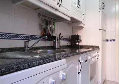 a kitchen with a sink and a counter top at Los Pinos 4 in Chiclana de la Frontera