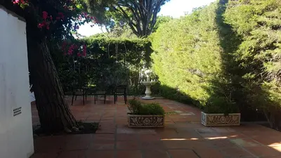 a small bedroom with a bed and a window at Chalet la barrosa a 800 mts playa in Chiclana de la Frontera